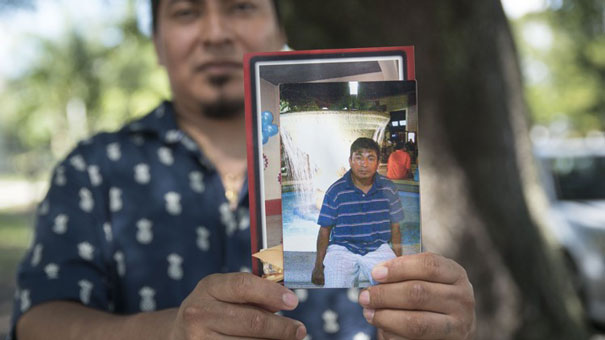 Thirty-two-year-old Harin Agustin poses for a portrait holding a photo of his older brother, Eugenio Danilo Agustin, in front of his West Palm Beach, Fla., home on Wednesday, August 16, 2017. On Monday, Eugenio and two other men were taken into custody by Border Patrol agents near the intersection of 44th Street and Broadway Avenue. (Andres Leiva / The Palm Beach Post)